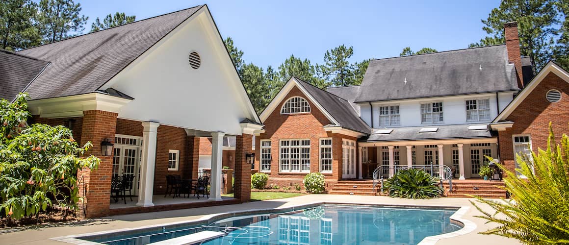 Brick house with pool and diving board